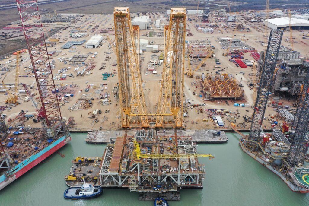 Offshore oil rig platform under construction near the shore.