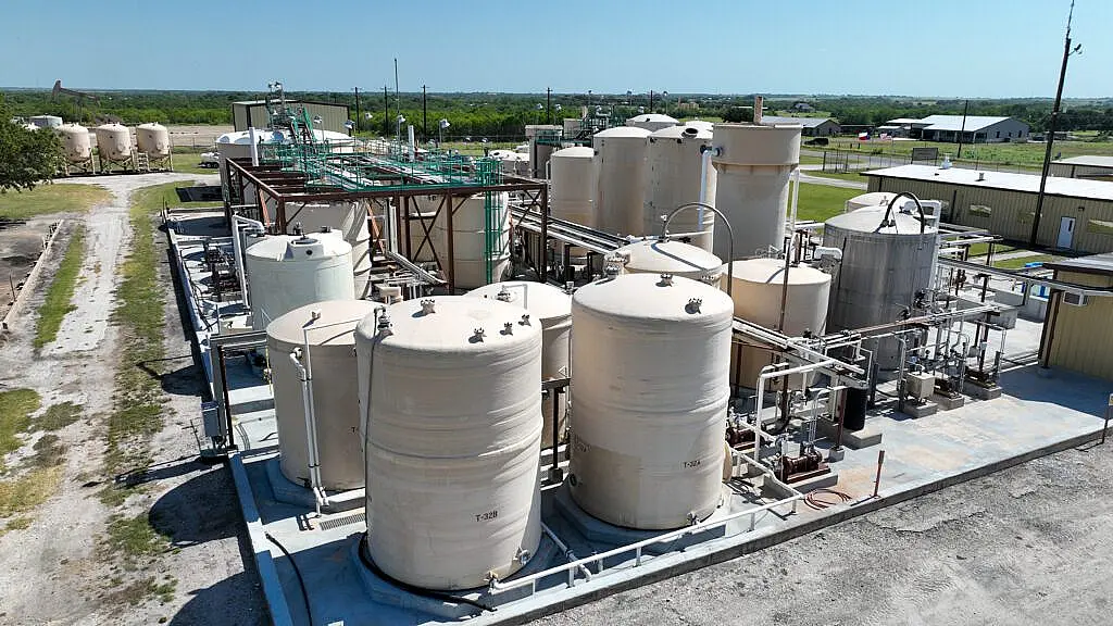 Industrial facility with large storage tanks outdoors.