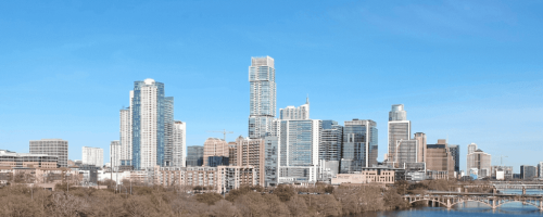 City skyline with river and clear sky.